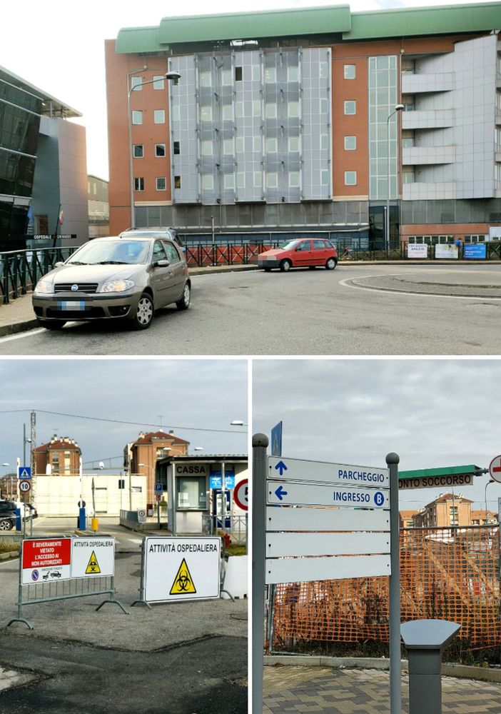 Le auto parcheggiate davanti alla rotatoria ed il parcheggio occupato dalle tende militari