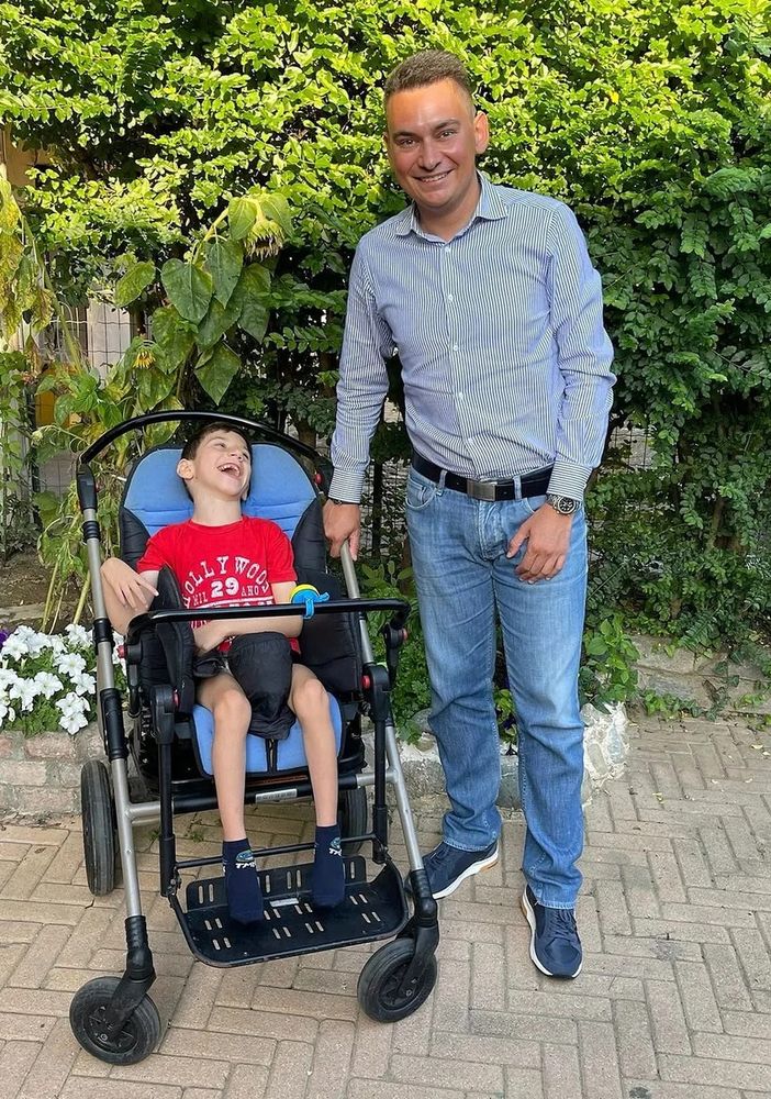 un bimbo e un adulto che lo tiene per mano
