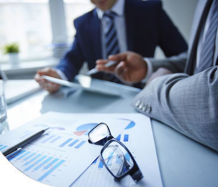 Persone al tavolo con numeri e computer